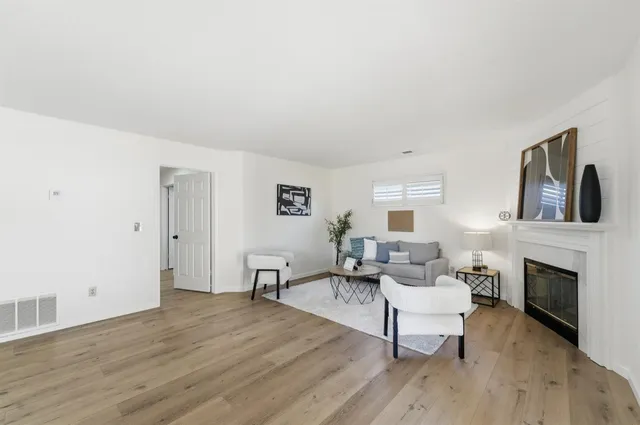a view of a hallway with wooden floor and bedroom