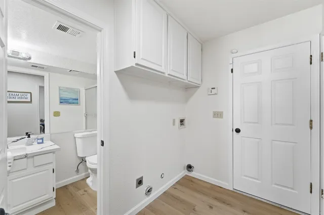 a en suite bathroom with a granite countertop sink and a mirror