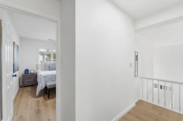 a bedroom with a bed and a lamp on dresser