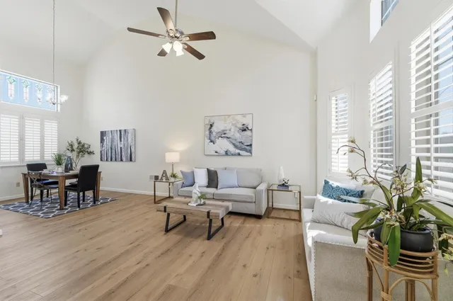 a living room with furniture and large windows