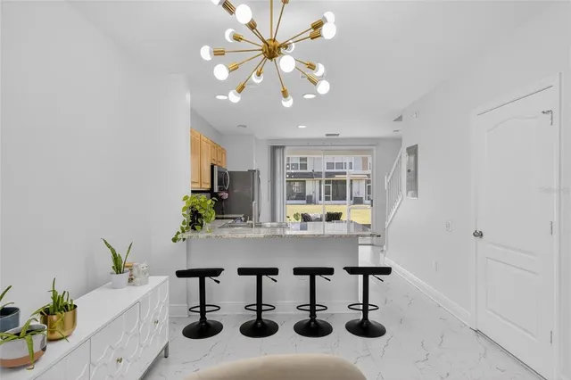 a kitchen with stainless steel appliances granite countertop a sink dishwasher a stove a microwave oven with cabinets and wooden floor