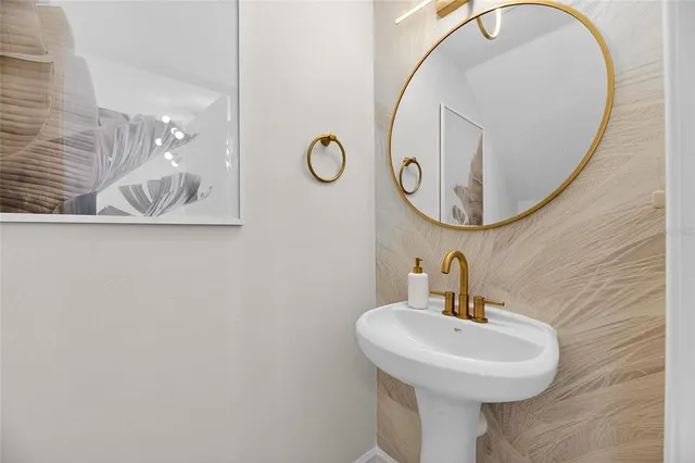 a spacious bedroom with a bed a tv and wooden floor