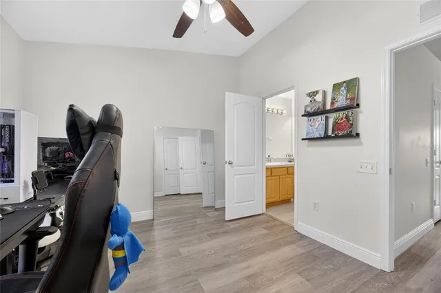 a view of a brick house with plants and large tree