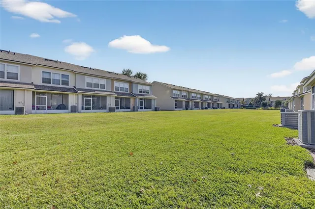an aerial view of a house with a yard and large trees