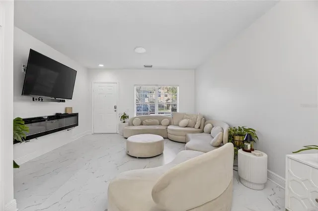 a living room with furniture and a chandelier