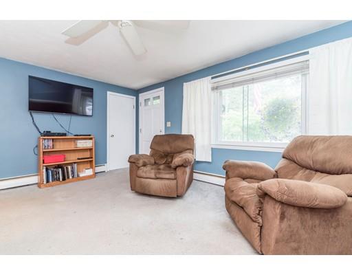 124 Lowell Road Pepperell, MA 01463 - Photo 11 of 27 a living room with furniture and a flat screen tv