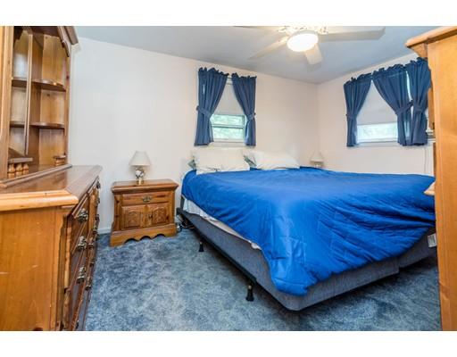 124 Lowell Road Pepperell, MA 01463 - Photo 18 of 27 a bedroom with a bed and a painting on the wall