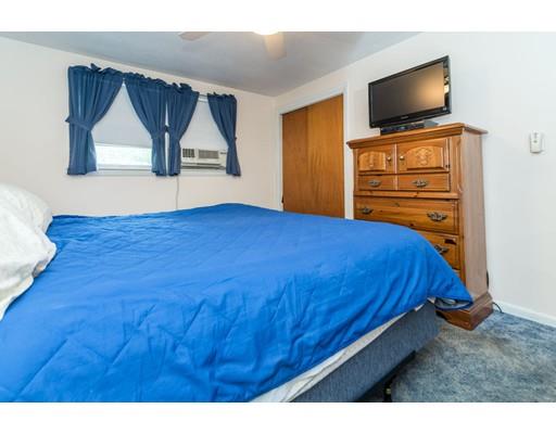 124 Lowell Road Pepperell, MA 01463 - Photo 19 of 27 a bedroom with a bed and a flat screen tv