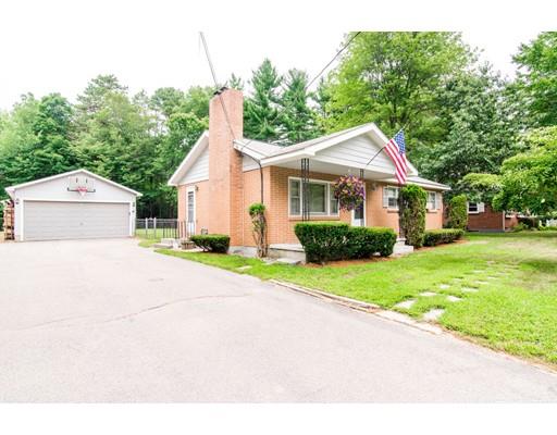 124 Lowell Road Pepperell, MA 01463 - Photo 27 of 27 a front view of a house with a yard and garage