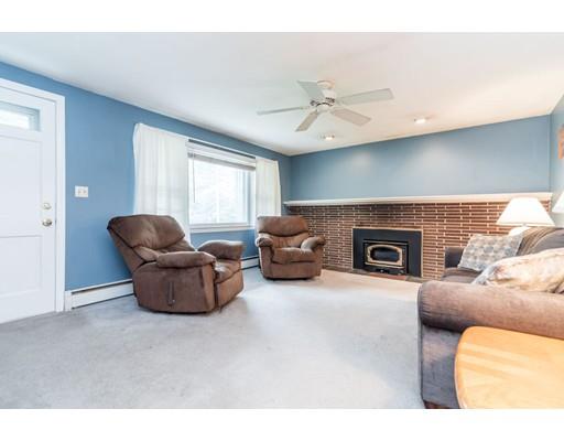 124 Lowell Road Pepperell, MA 01463 - Photo 8 of 27 a living room with furniture and a fireplace