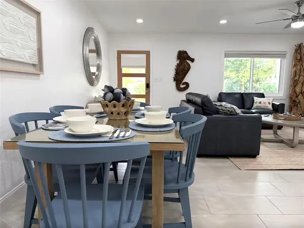 a view of a dining room with furniture and a large window