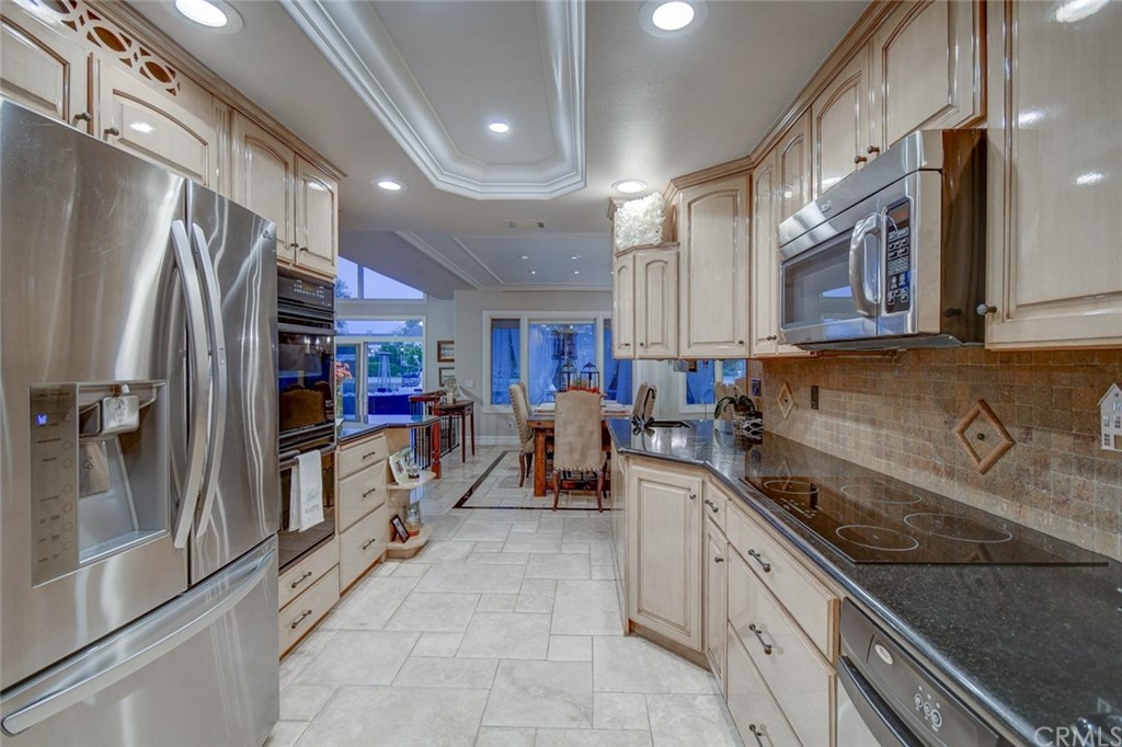 3901 Aruba Circle Huntington Beach, CA 92649 - Photo 13 of 56 a kitchen with stainless steel appliances granite countertop a refrigerator and a sink