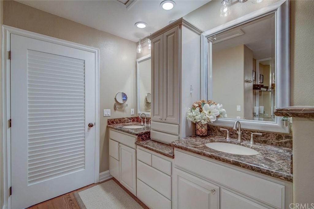 3901 Aruba Circle Huntington Beach, CA 92649 - Photo 18 of 56 a bathroom with a double vanity sink and a mirror