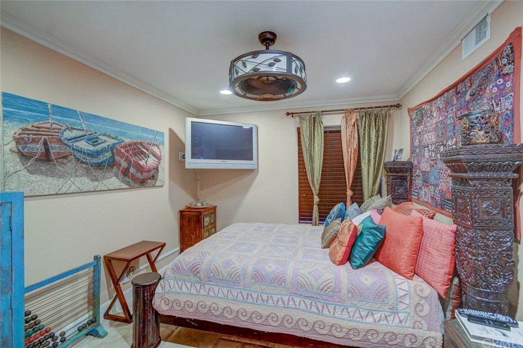 3901 Aruba Circle Huntington Beach, CA 92649 - Photo 19 of 56 a bedroom with a bed and a chandelier