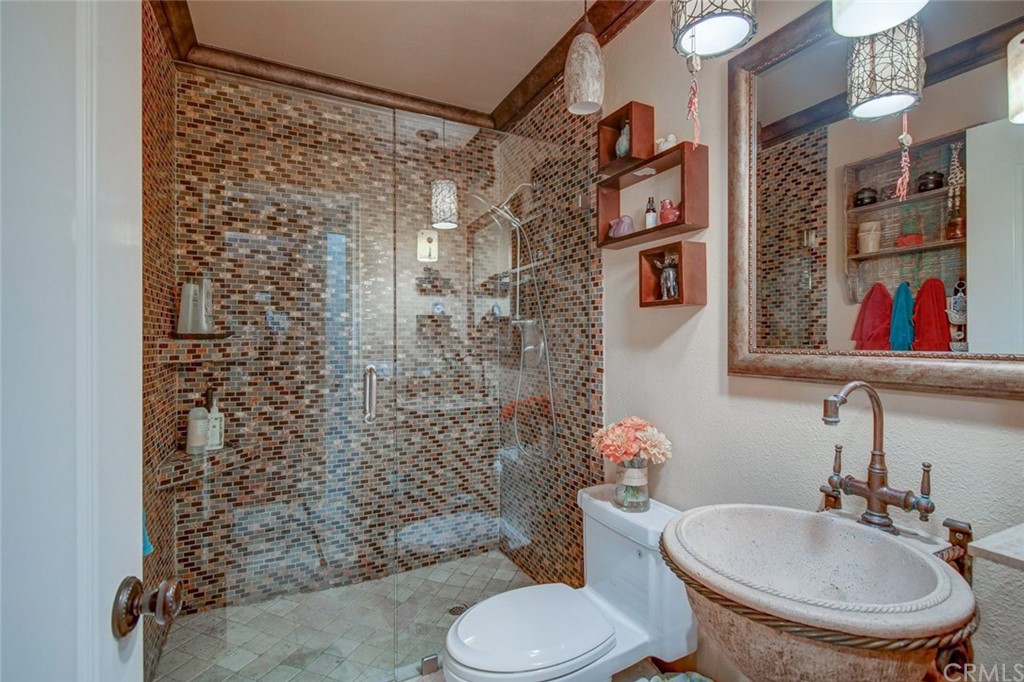 3901 Aruba Circle Huntington Beach, CA 92649 - Photo 22 of 56 a bathroom with a toilet sink and shower curtain