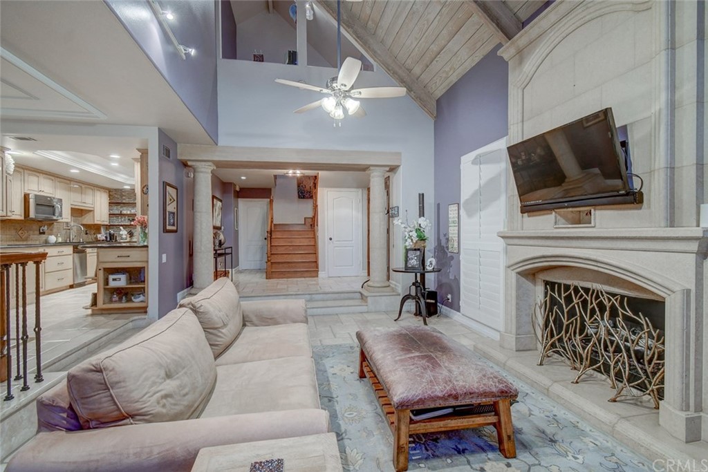 3901 Aruba Circle Huntington Beach, CA 92649 - Photo 33 of 56 a living room with furniture a flat screen tv and a fireplace