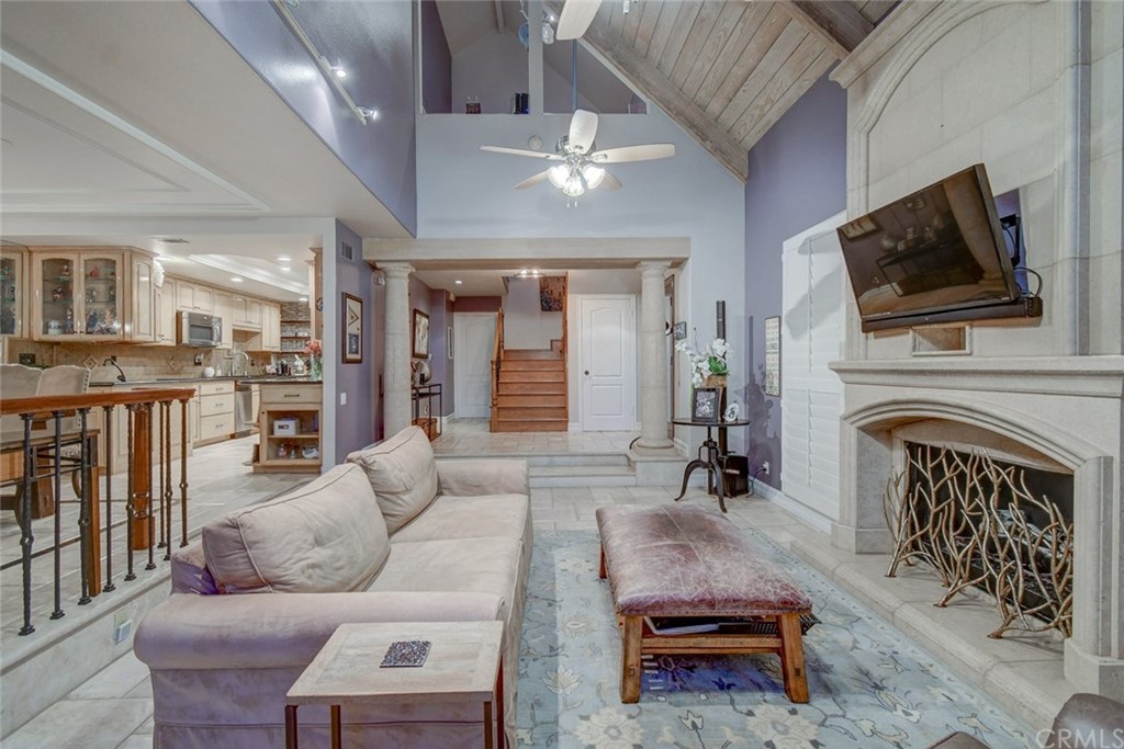 3901 Aruba Circle Huntington Beach, CA 92649 - Photo 34 of 56 a living room with furniture a fireplace and a flat screen tv