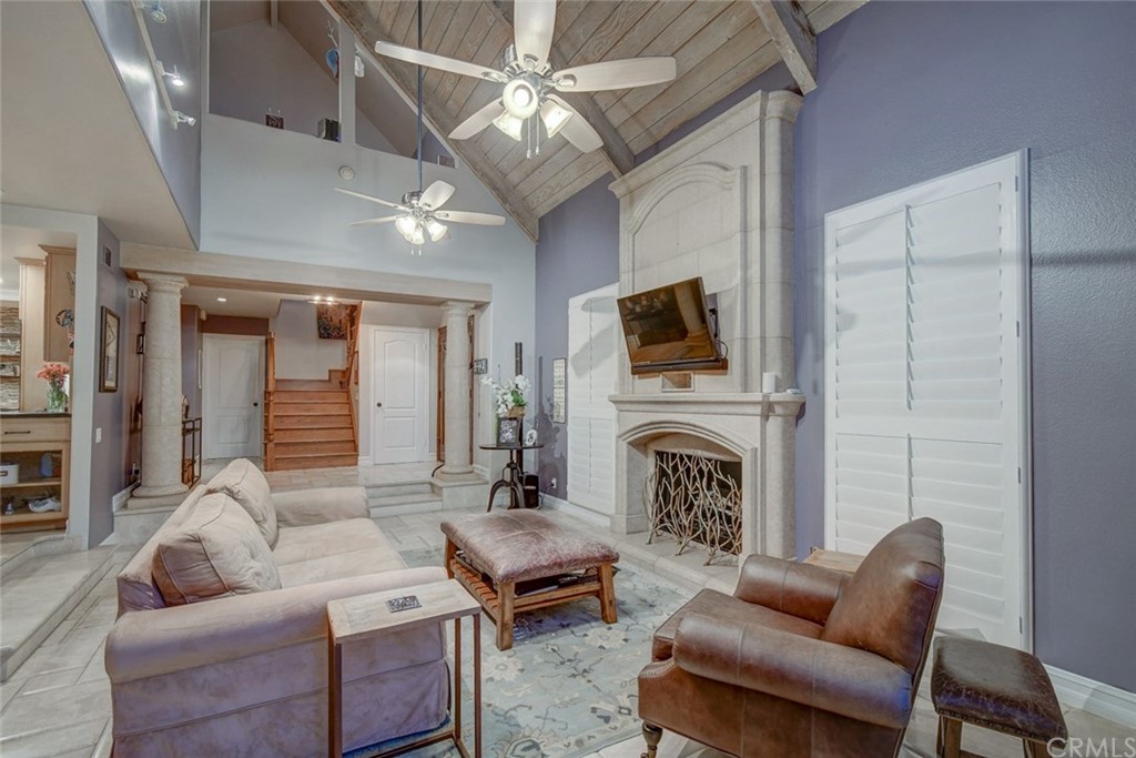 3901 Aruba Circle Huntington Beach, CA 92649 - Photo 35 of 56 a living room with furniture a fireplace and a flat screen tv