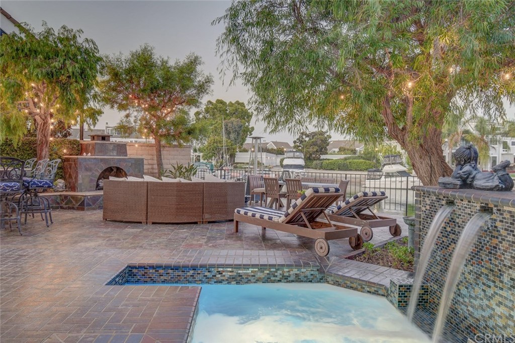 3901 Aruba Circle Huntington Beach, CA 92649 - Photo 39 of 56 a view of a patio with table and chairs potted plants and large tree
