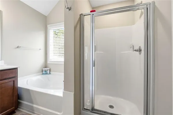 a bathroom with a bathtub and a shower