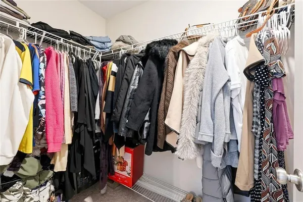 a view of walk in closet with clothes