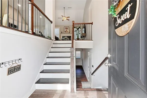 a view of staircase with lots of frames on wall and a window