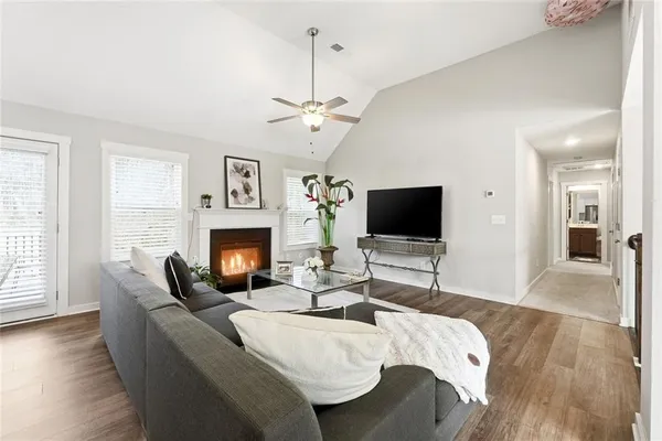 a living room with fireplace furniture and a flat screen tv
