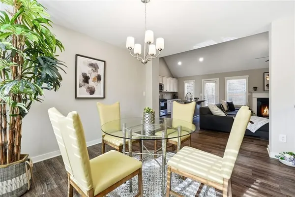 a view of a dining room with furniture wooden floor and chandelier