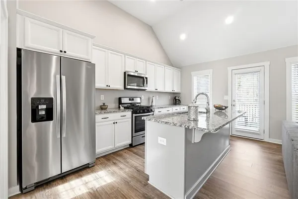 a kitchen with stainless steel appliances a refrigerator stove and sink