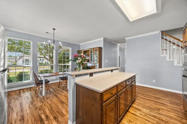 a view of kitchen island with furniture and wooden floor