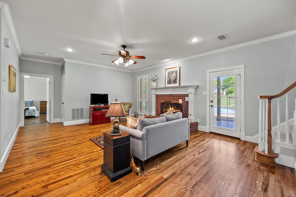425 Chippendale Drive Heath, TX 75032 - Photo 16 of 37 a living room with furniture and a fireplace