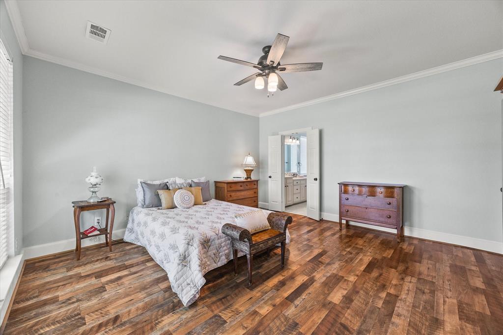 425 Chippendale Drive Heath, TX 75032 - Photo 17 of 37 a bedroom with a bed and a chandelier