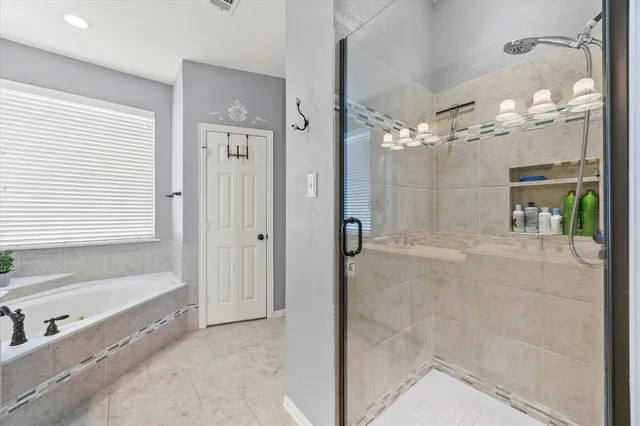 a bathroom with a bathtub and a shower