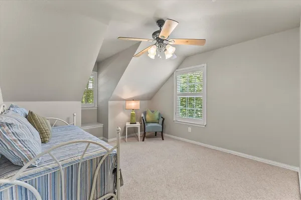 a bedroom with furniture and a window