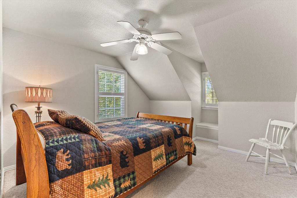 425 Chippendale Drive Heath, TX 75032 - Photo 22 of 37 a bedroom with a bed and a chandelier