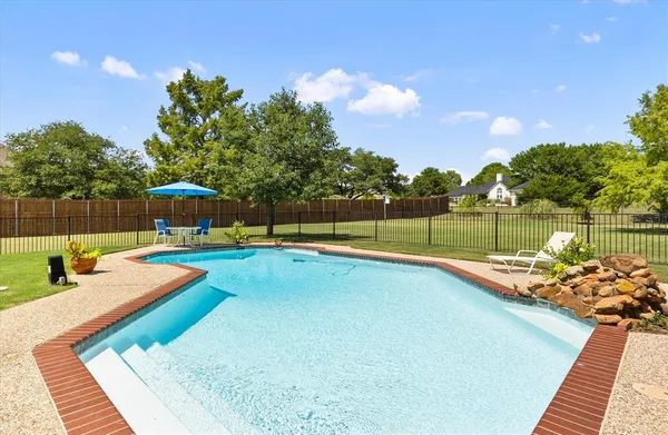 a view of a backyard with swimming pool