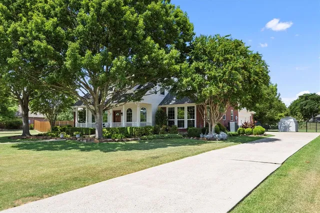 an aerial view of residential houses with outdoor space and street view