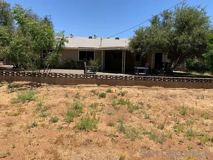 28757 West Worcester Road Menifee, CA 92586 - Photo 3 of 21 a view of a house with a yard and large tree