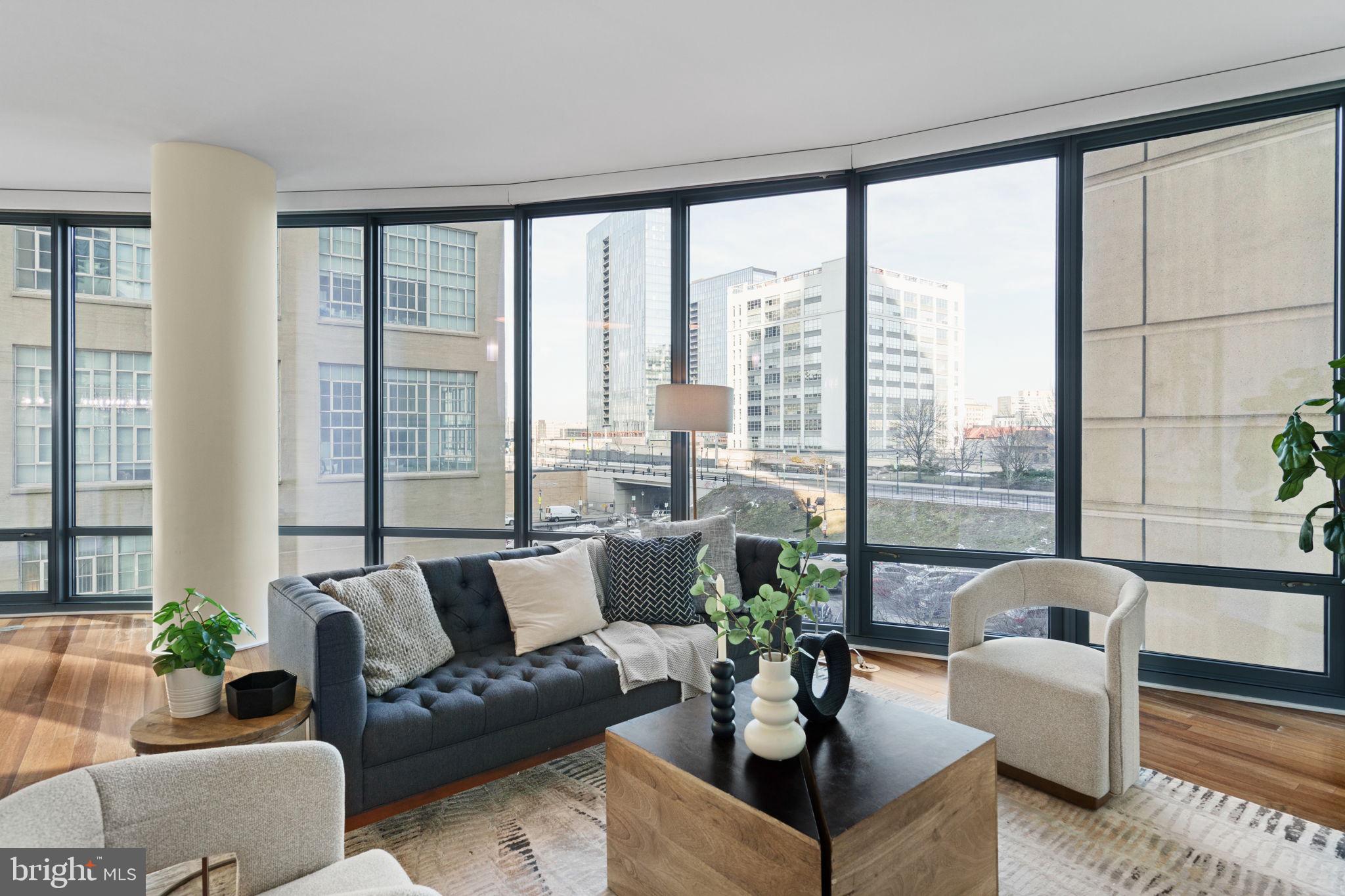 2101 Market Street, Unit 302 Philadelphia, PA 19103 - Photo 11 of 53 a living room with furniture and a large window