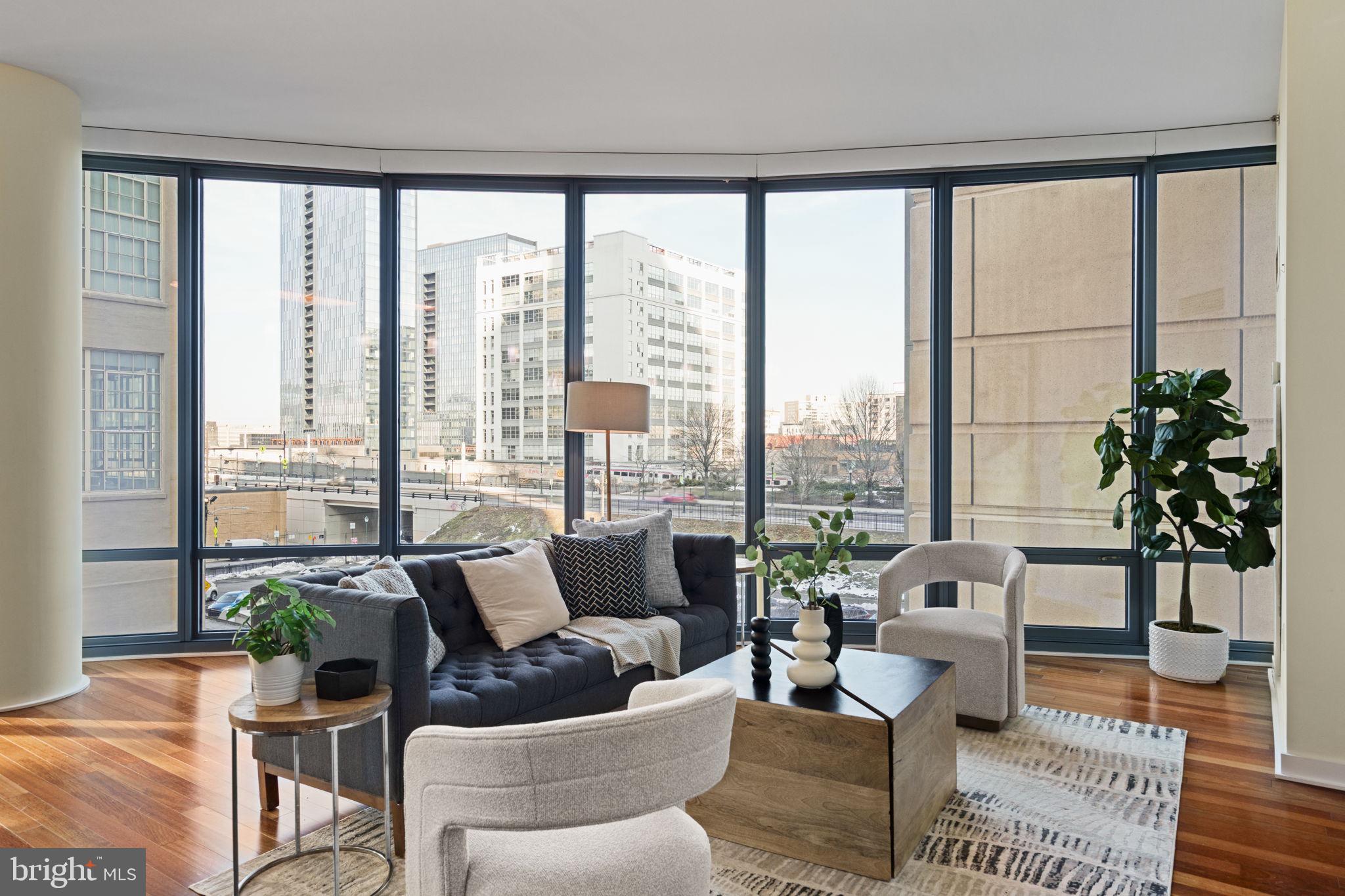 2101 Market Street, Unit 302 Philadelphia, PA 19103 - Photo 18 of 53 a living room with furniture and floor to ceiling windows
