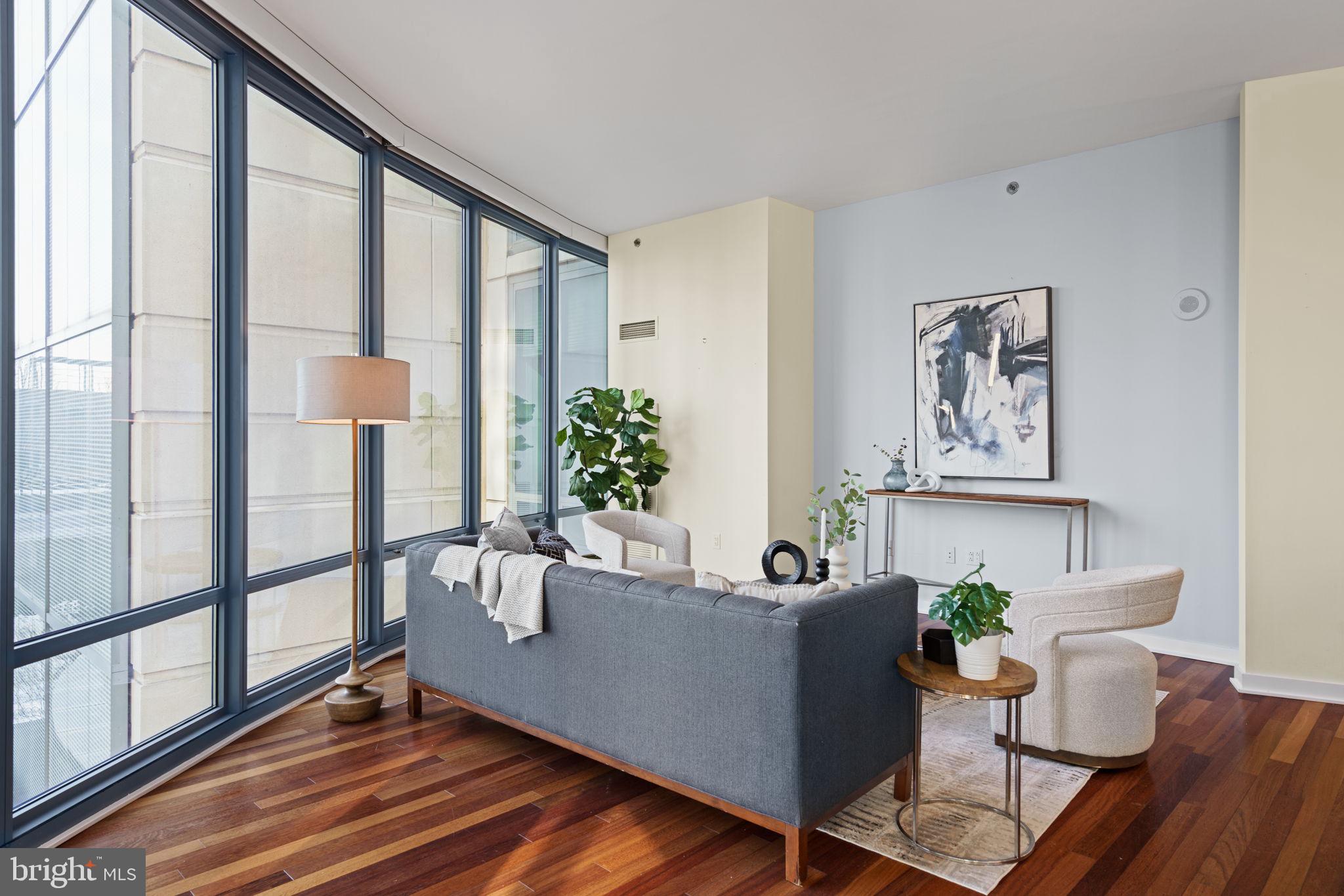 2101 Market Street, Unit 302 Philadelphia, PA 19103 - Photo 19 of 53 a living room with furniture and a potted plant