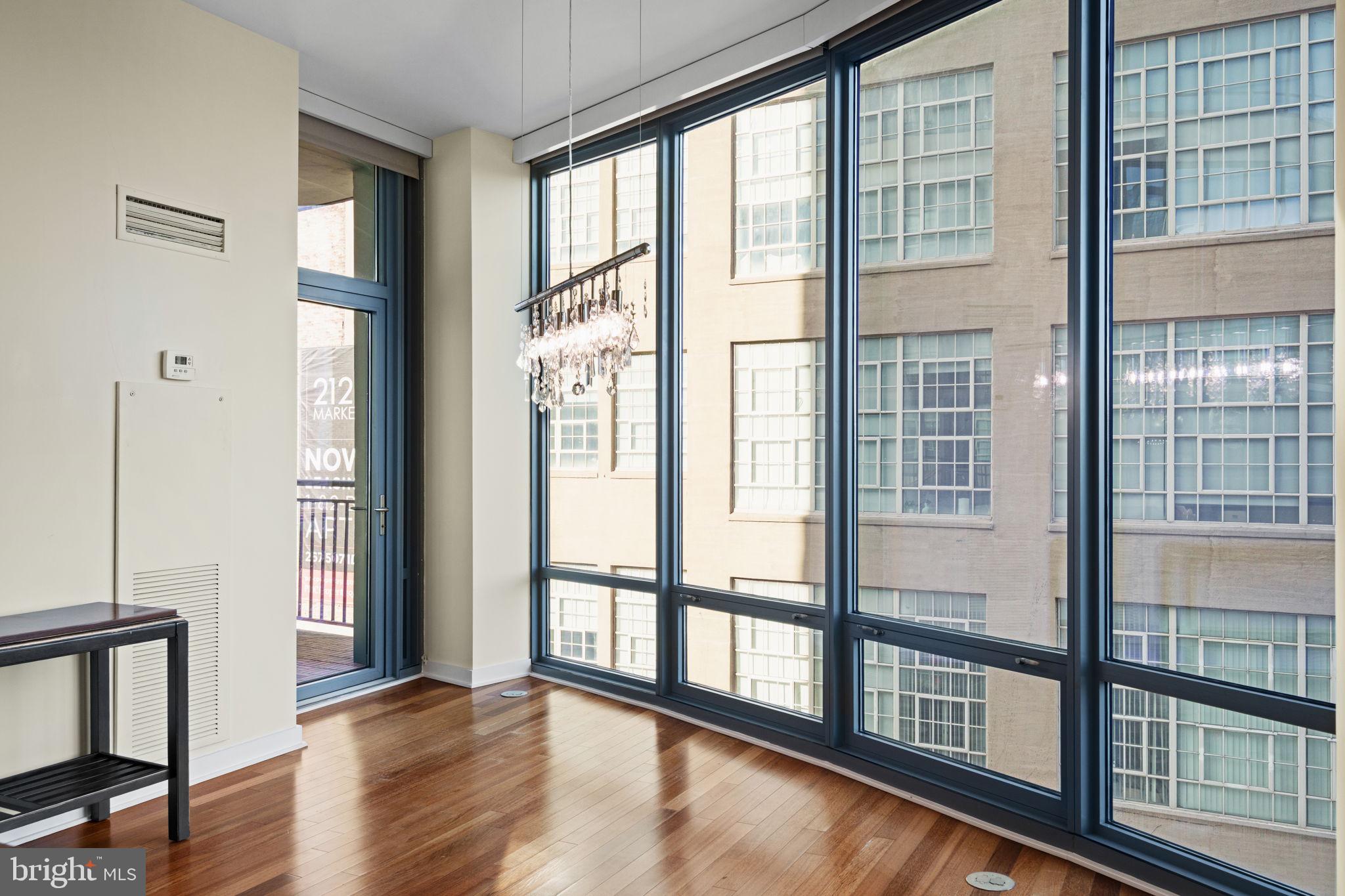 2101 Market Street, Unit 302 Philadelphia, PA 19103 - Photo 21 of 53 a view of an empty room with wooden floor and a window