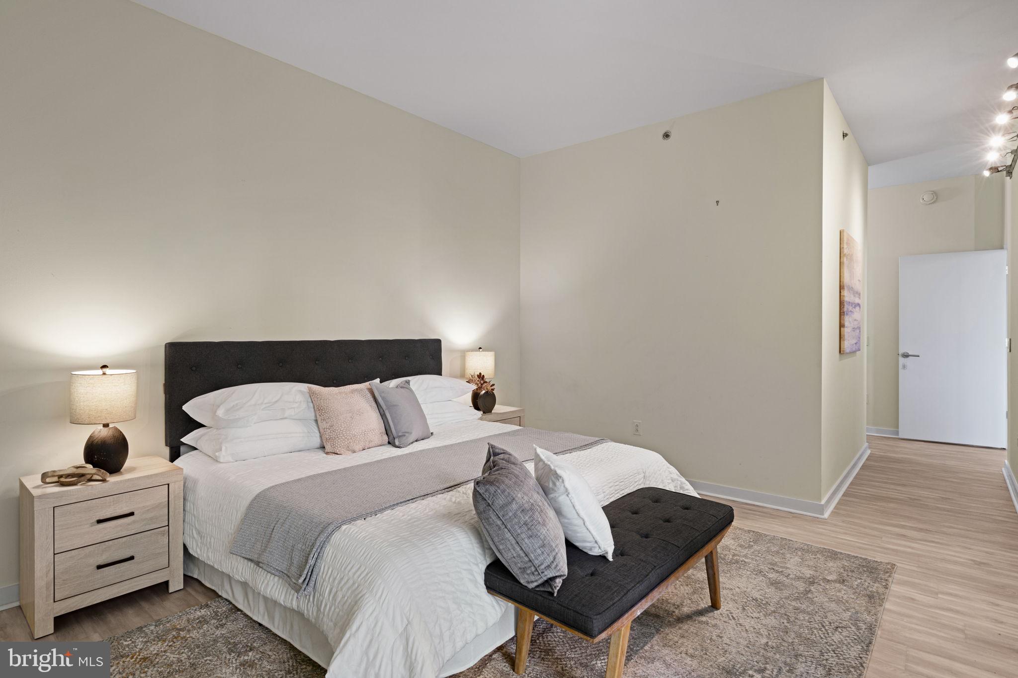 2101 Market Street, Unit 302 Philadelphia, PA 19103 - Photo 32 of 53 a bedroom with a bed and a chair