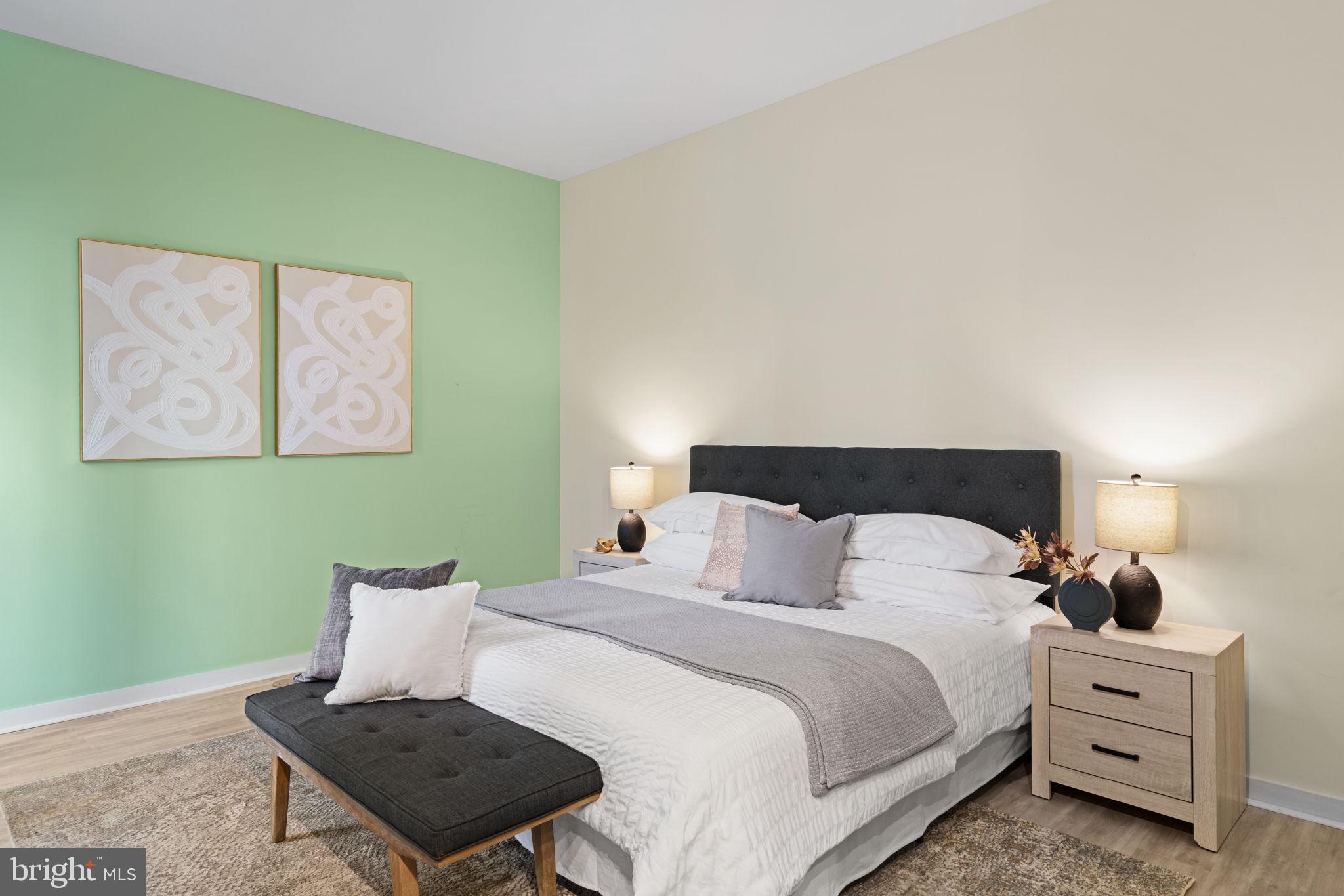 2101 Market Street, Unit 302 Philadelphia, PA 19103 - Photo 34 of 53 a bedroom with a bed and a lamp on dresser