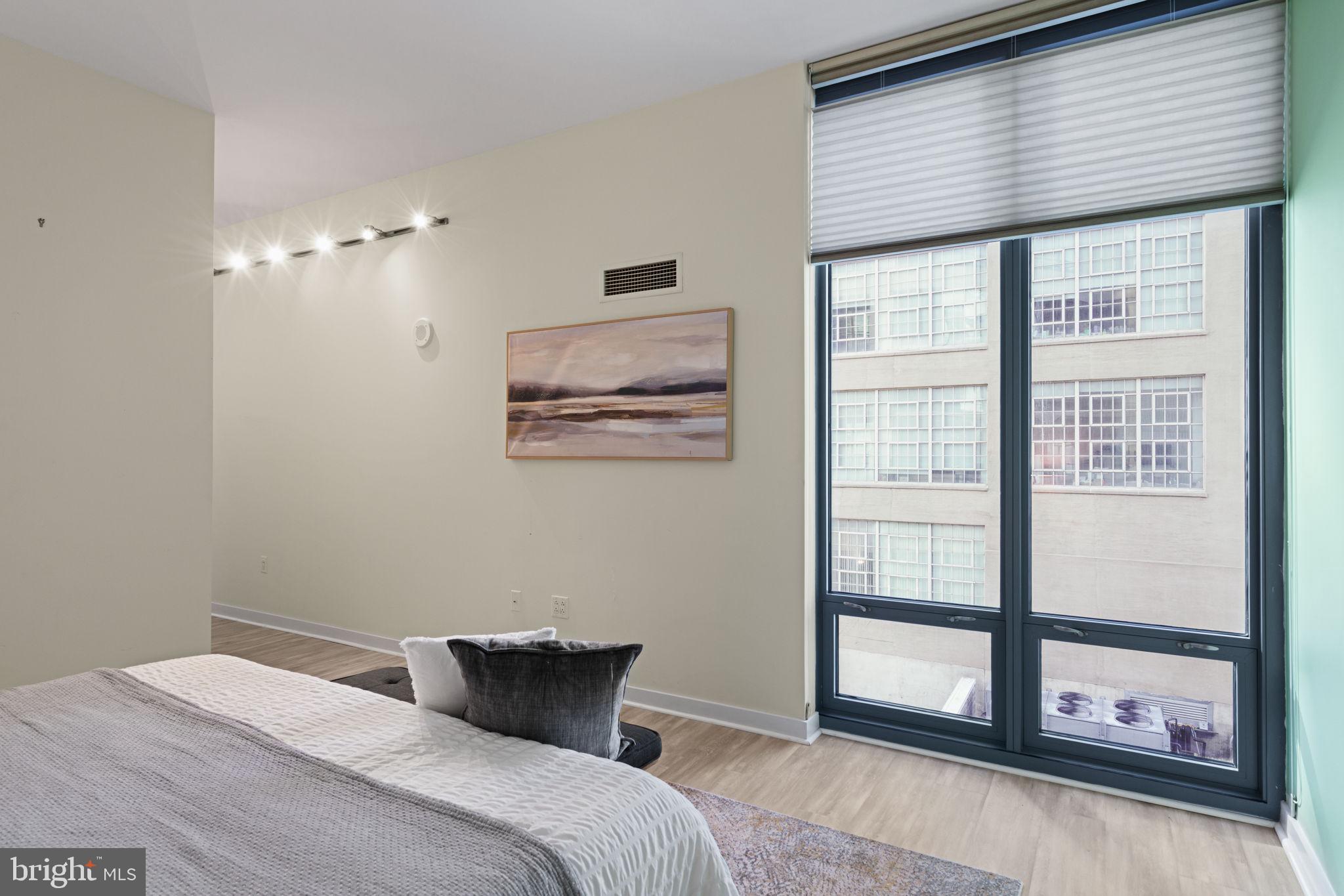 2101 Market Street, Unit 302 Philadelphia, PA 19103 - Photo 35 of 53 a bedroom with a bed and a window
