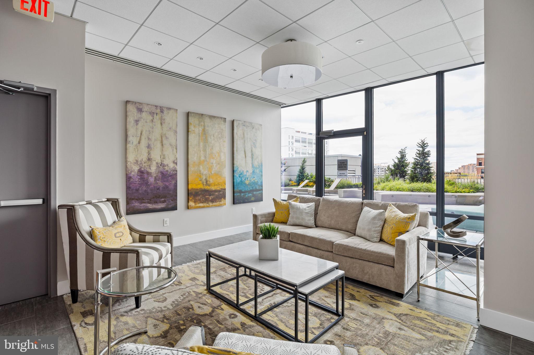 2101 Market Street, Unit 302 Philadelphia, PA 19103 - Photo 47 of 53 a living room with furniture and a floor to ceiling window