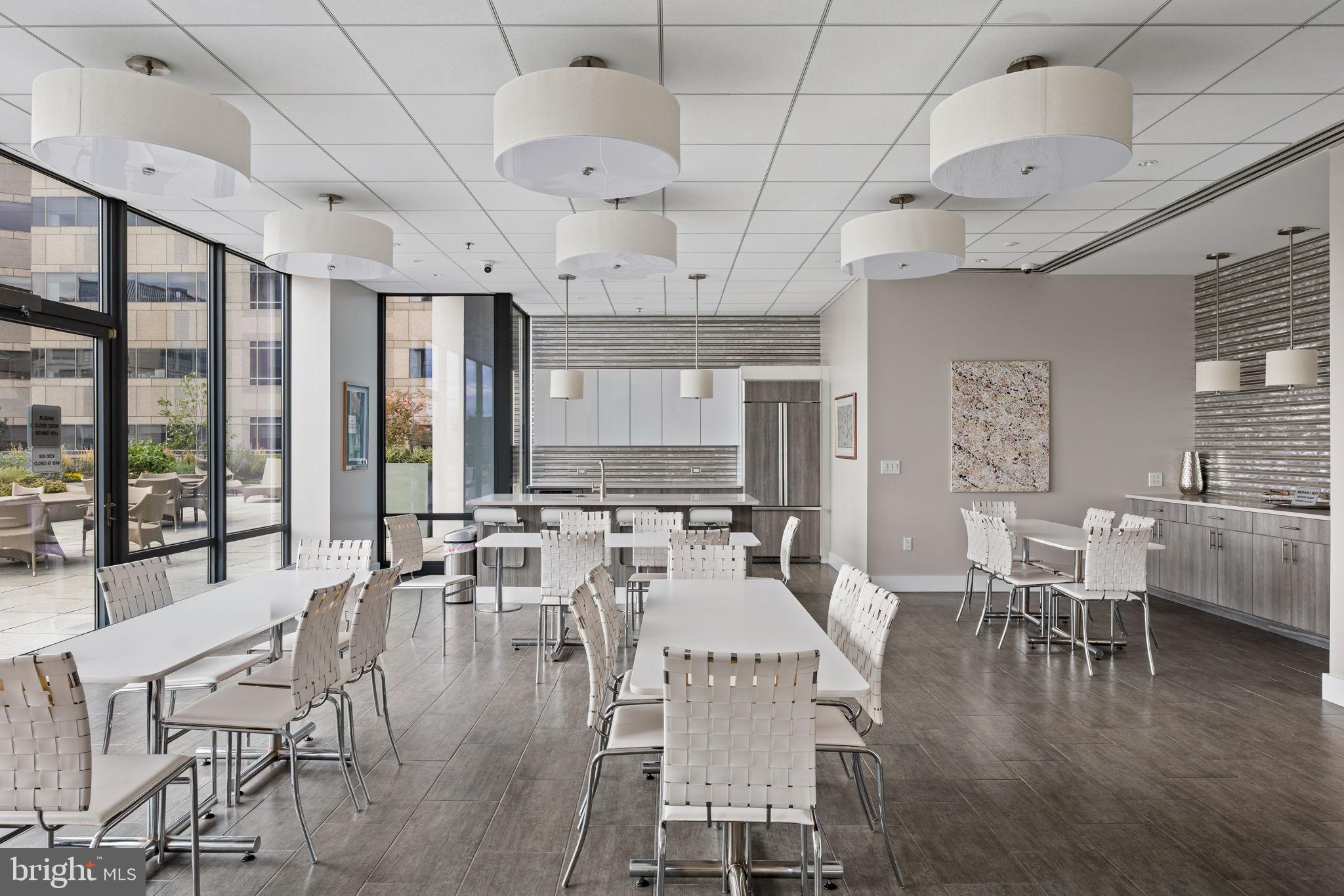 2101 Market Street, Unit 302 Philadelphia, PA 19103 - Photo 49 of 53 a room with lots of tables a large window and chairs