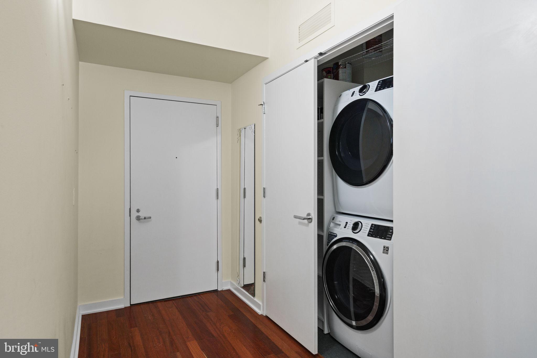 2101 Market Street, Unit 302 Philadelphia, PA 19103 - Photo 6 of 53 a utility room with dryer washer and a view of bedroom