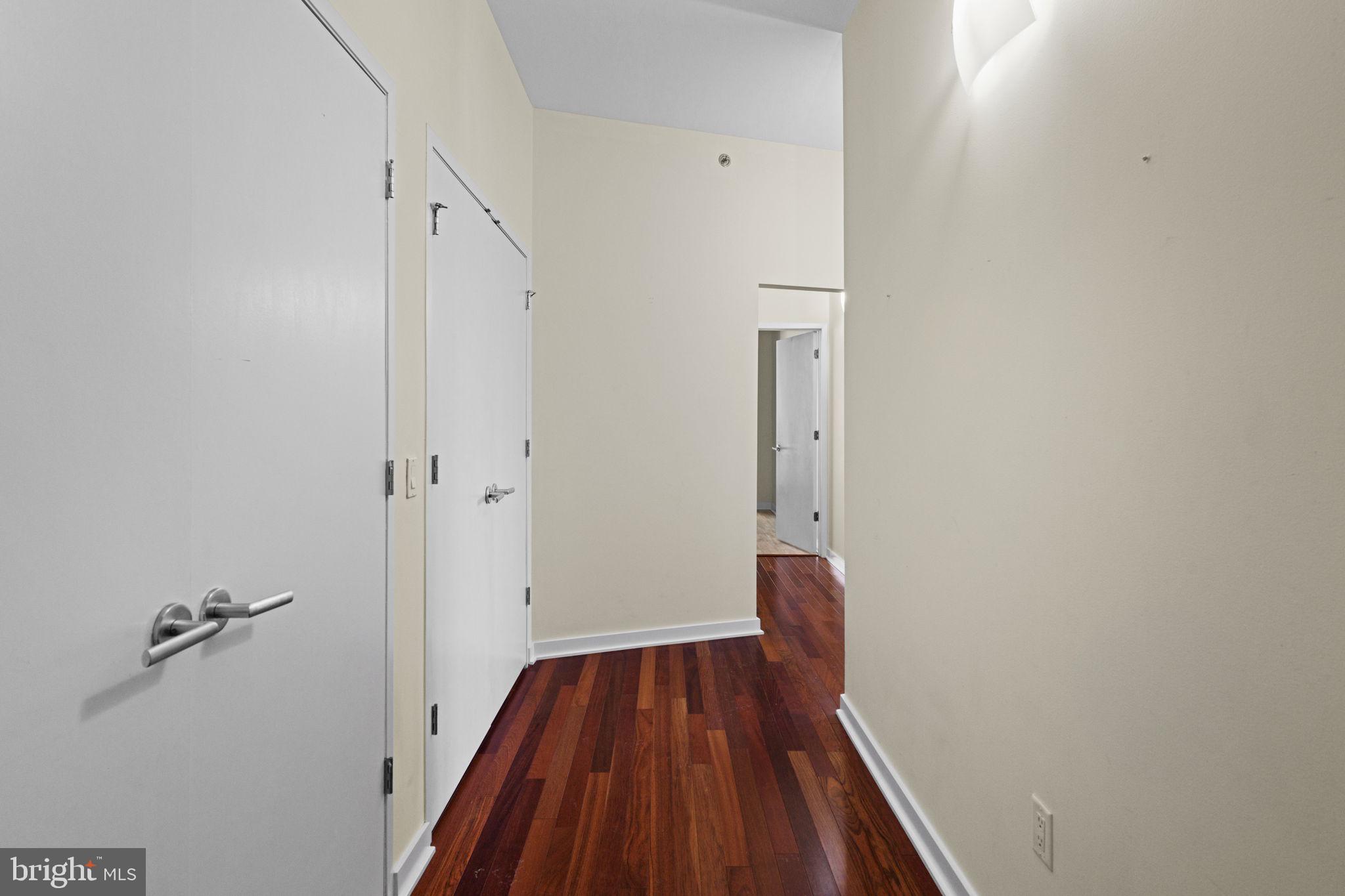 2101 Market Street, Unit 302 Philadelphia, PA 19103 - Photo 7 of 53 a view of a room with wooden floor and a ceiling fan