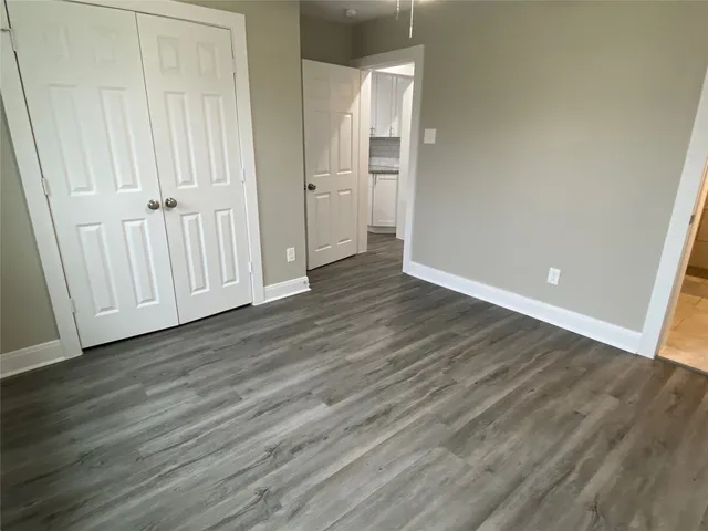 a view of wooden floor and windows in a room
